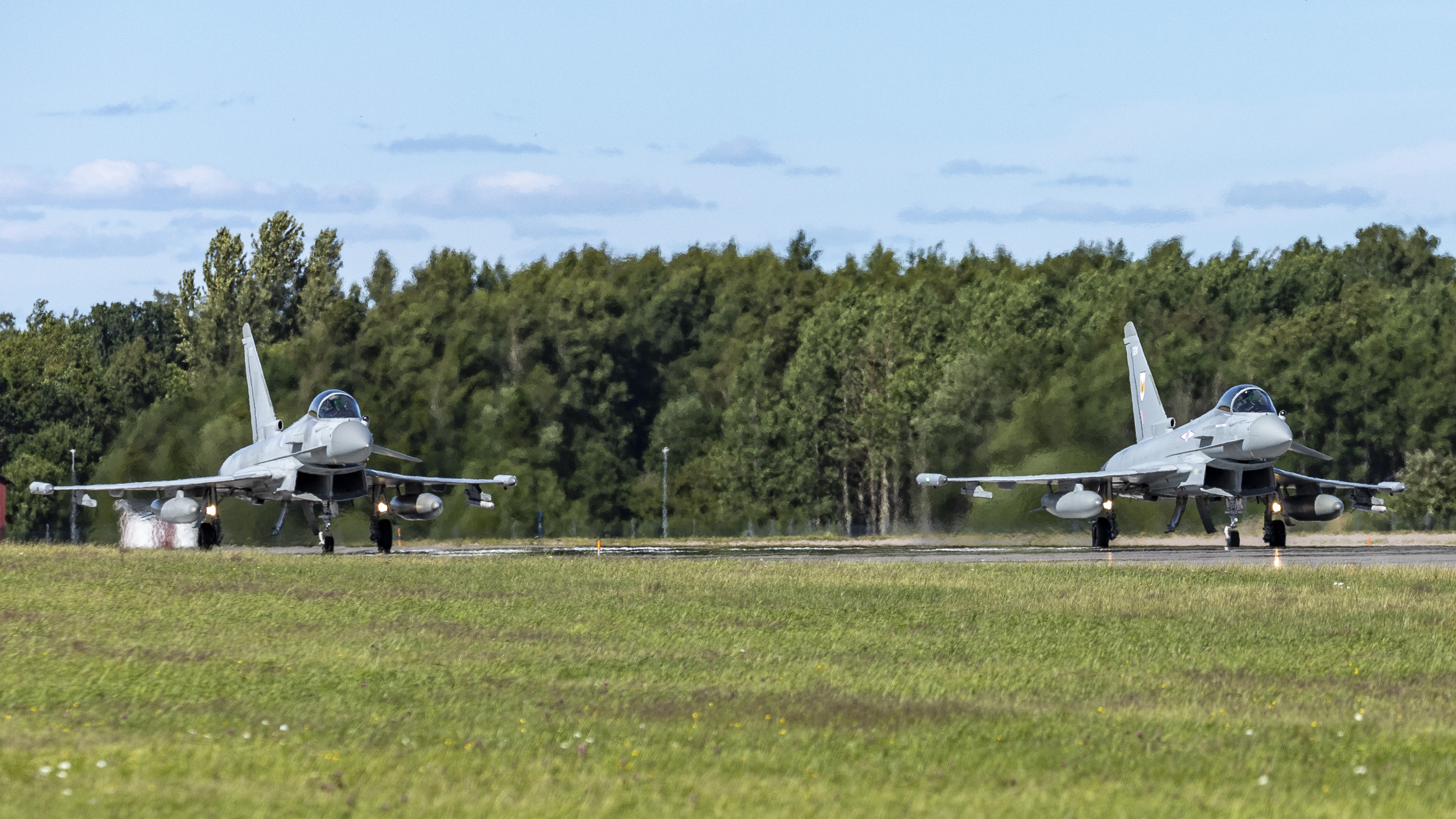 Image shows two RAF Typhoons on the runway about to take off.
